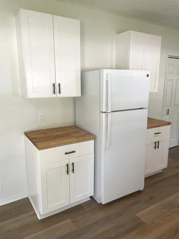 a white refrigerator freezer sitting inside of a kitchen