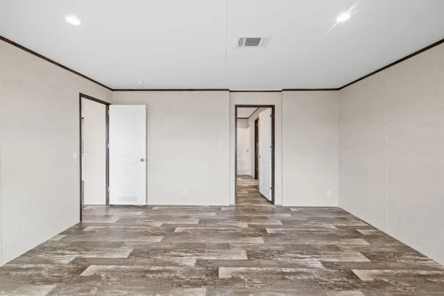 an empty room with windows and closet