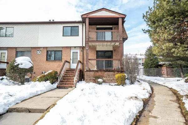 a view of a house with snow on the background