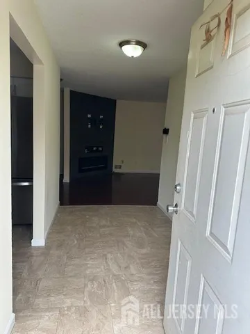 a kitchen with white cabinets and appliances