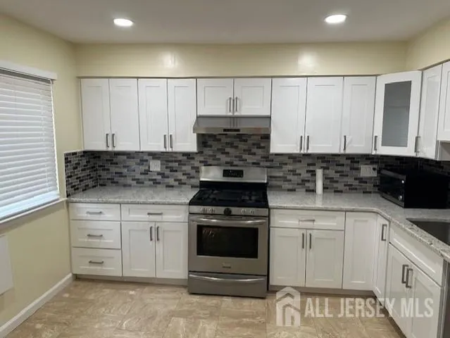 a kitchen with a refrigerator and a sink