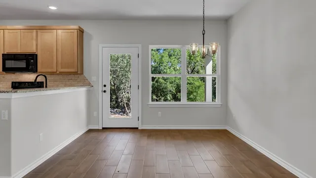 a view of a kitchen with a sink a refrigerator and window