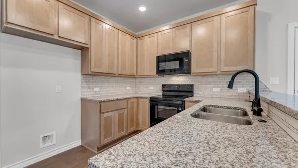 a kitchen with appliances cabinets and a window
