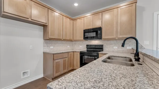 a kitchen with appliances cabinets and a window