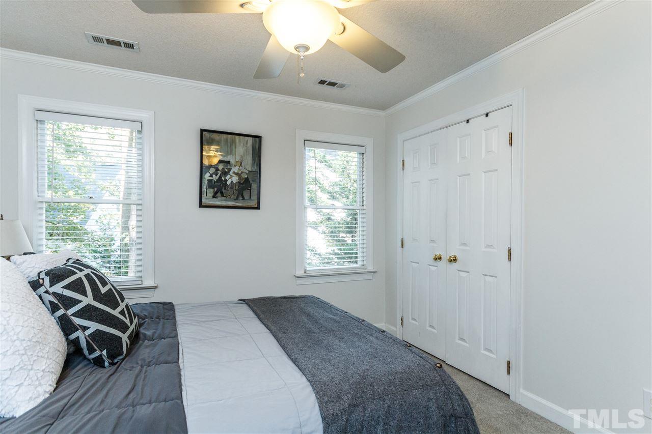 4500 Rutland Court Raleigh, NC 27613 - Photo 16 of 23 a bed room with a bed and a chair