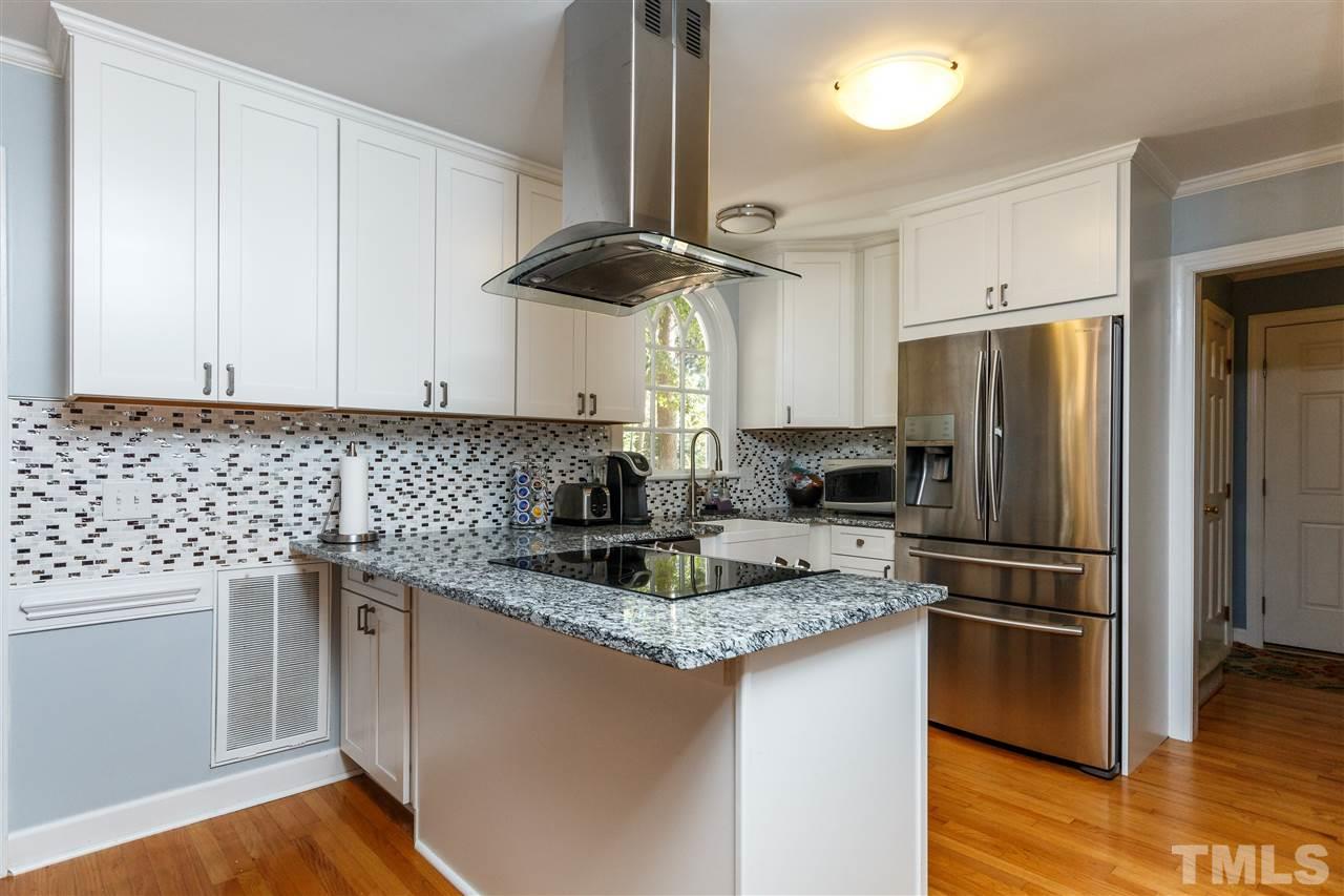 4500 Rutland Court Raleigh, NC 27613 - Photo 3 of 23 a kitchen with stainless steel appliances granite countertop a stove a refrigerator and a sink