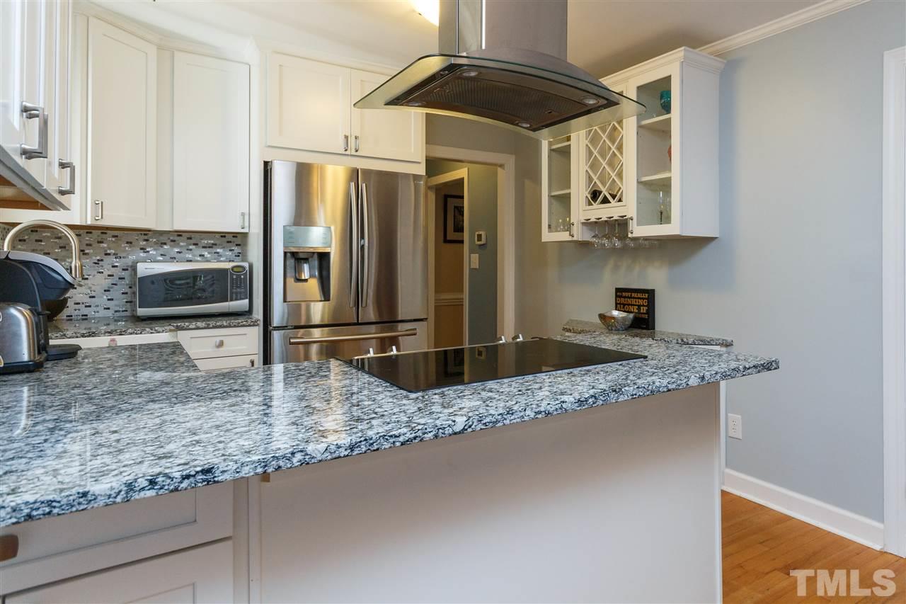 4500 Rutland Court Raleigh, NC 27613 - Photo 4 of 23 a kitchen with granite countertop a sink a stove and cabinets