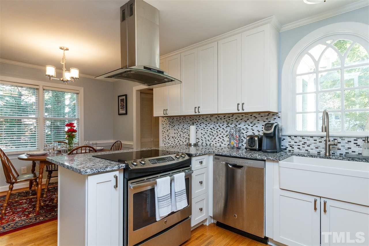 4500 Rutland Court Raleigh, NC 27613 - Photo 5 of 23 a kitchen with stainless steel appliances granite countertop a stove a sink and a microwave
