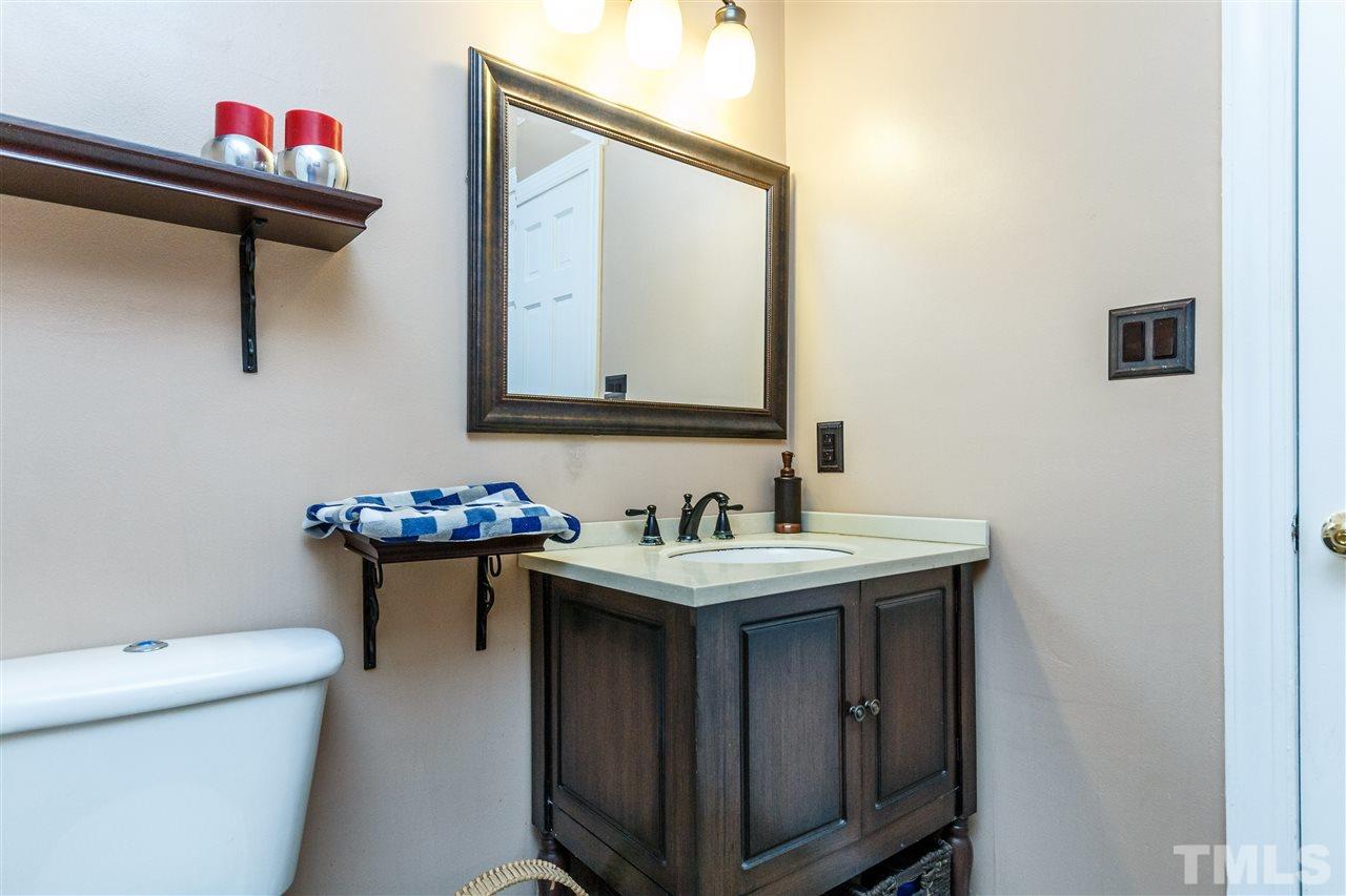 4500 Rutland Court Raleigh, NC 27613 - Photo 8 of 23 a bathroom with a toilet sink vanity and mirror