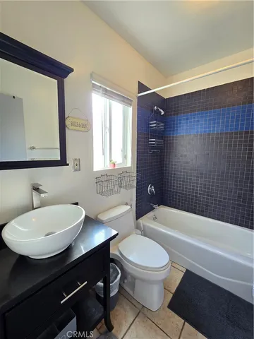 a bathroom with a sink a toilet a mirror and shower