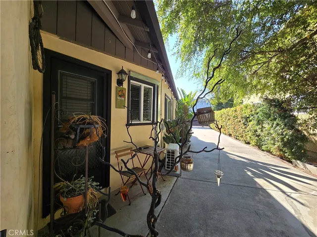a view of a porch with chairs and potted plants