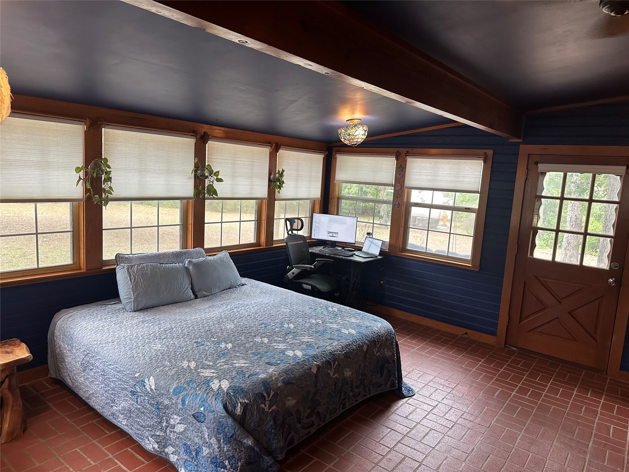 1053 East County Rd F Lexington, TX 78947 - Photo 14 of 38 a bedroom with a large bed and a large window