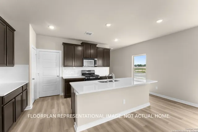 a view of kitchen with sink and wooden floor