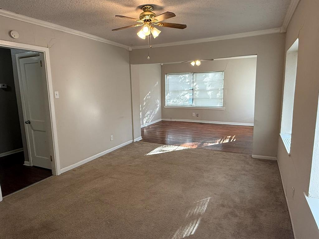 4216 Knoll Drive Waco, TX 76708 - Photo 4 of 12 an empty room with windows and fan