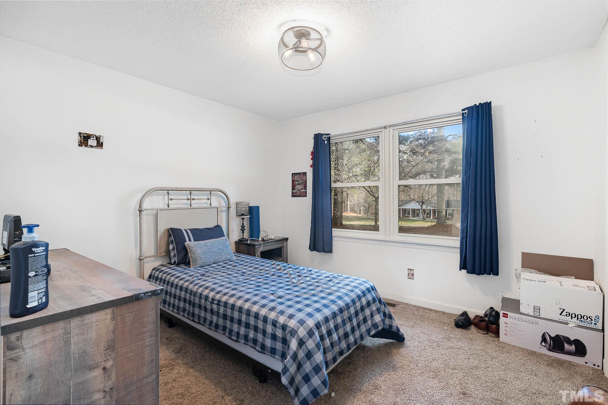 1613 Sanders Road Stem, NC 27581 - Photo 11 of 19 a bedroom with a bed and a window
