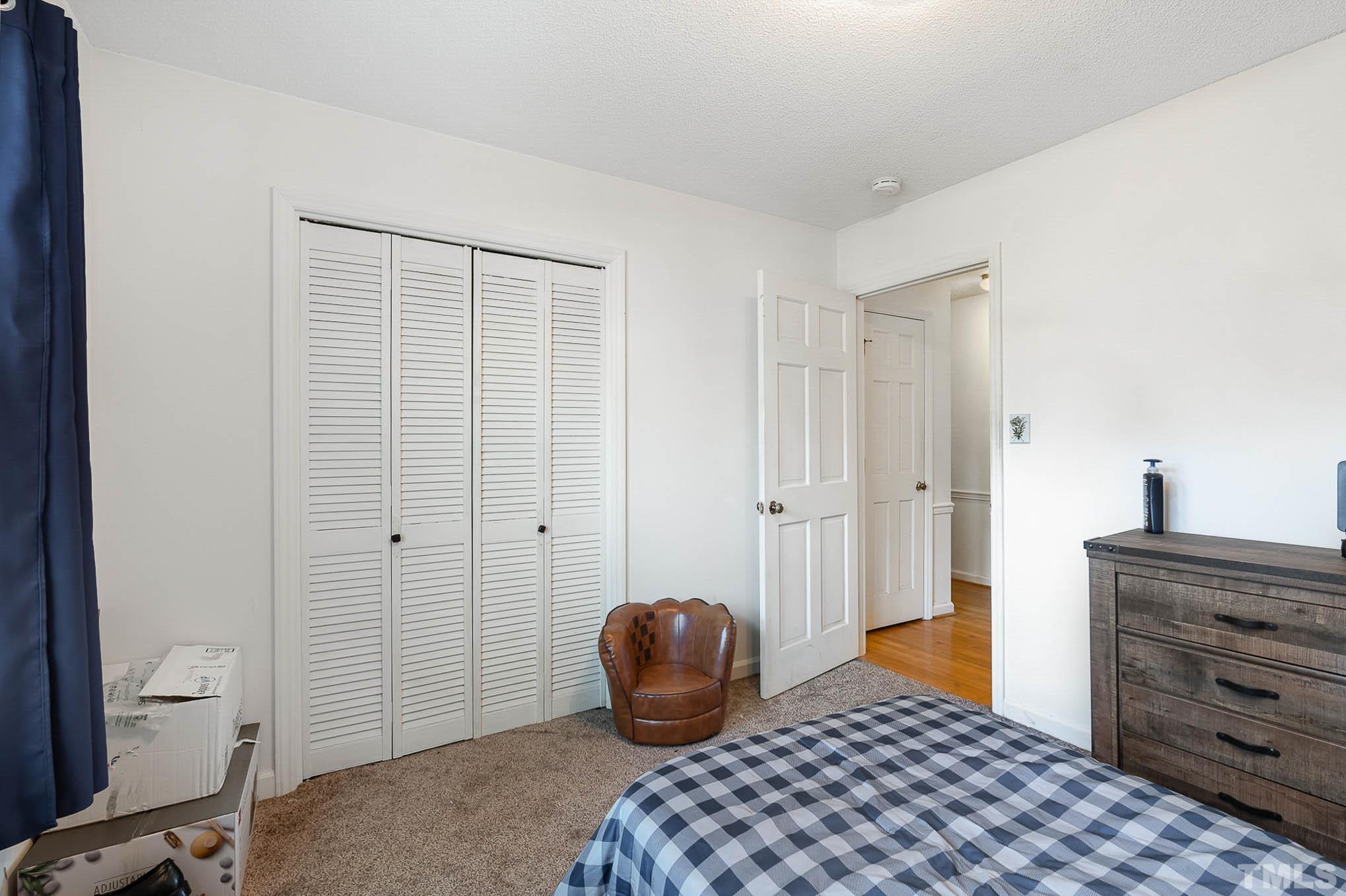 1613 Sanders Road Stem, NC 27581 - Photo 12 of 19 a bedroom with a bed and a dresser