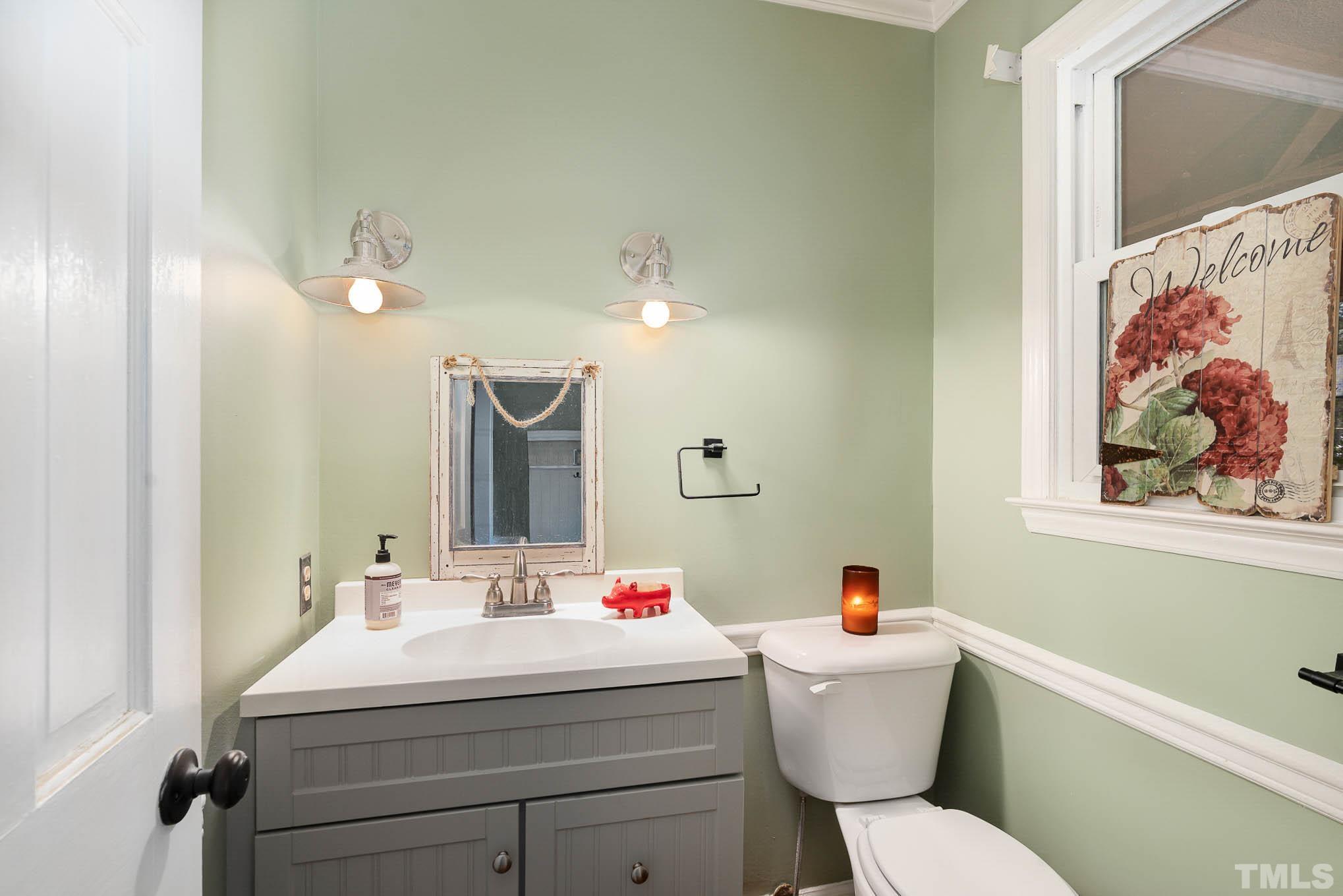 1613 Sanders Road Stem, NC 27581 - Photo 14 of 19 a bathroom with a sink mirror and toilet