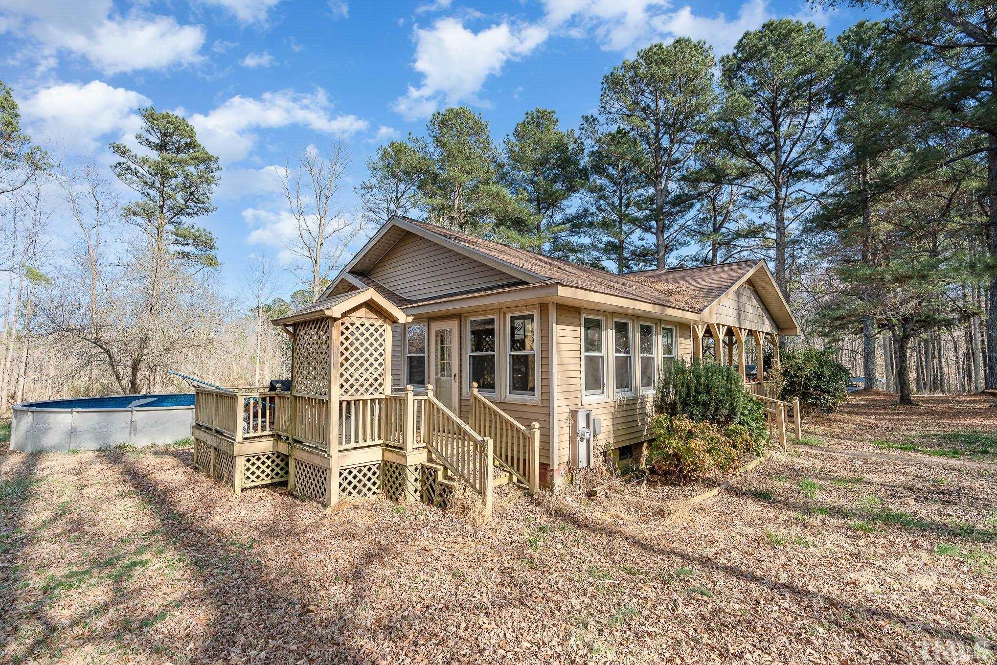 1613 Sanders Road Stem, NC 27581 - Photo 17 of 19 a house that has a lot of windows and plants
