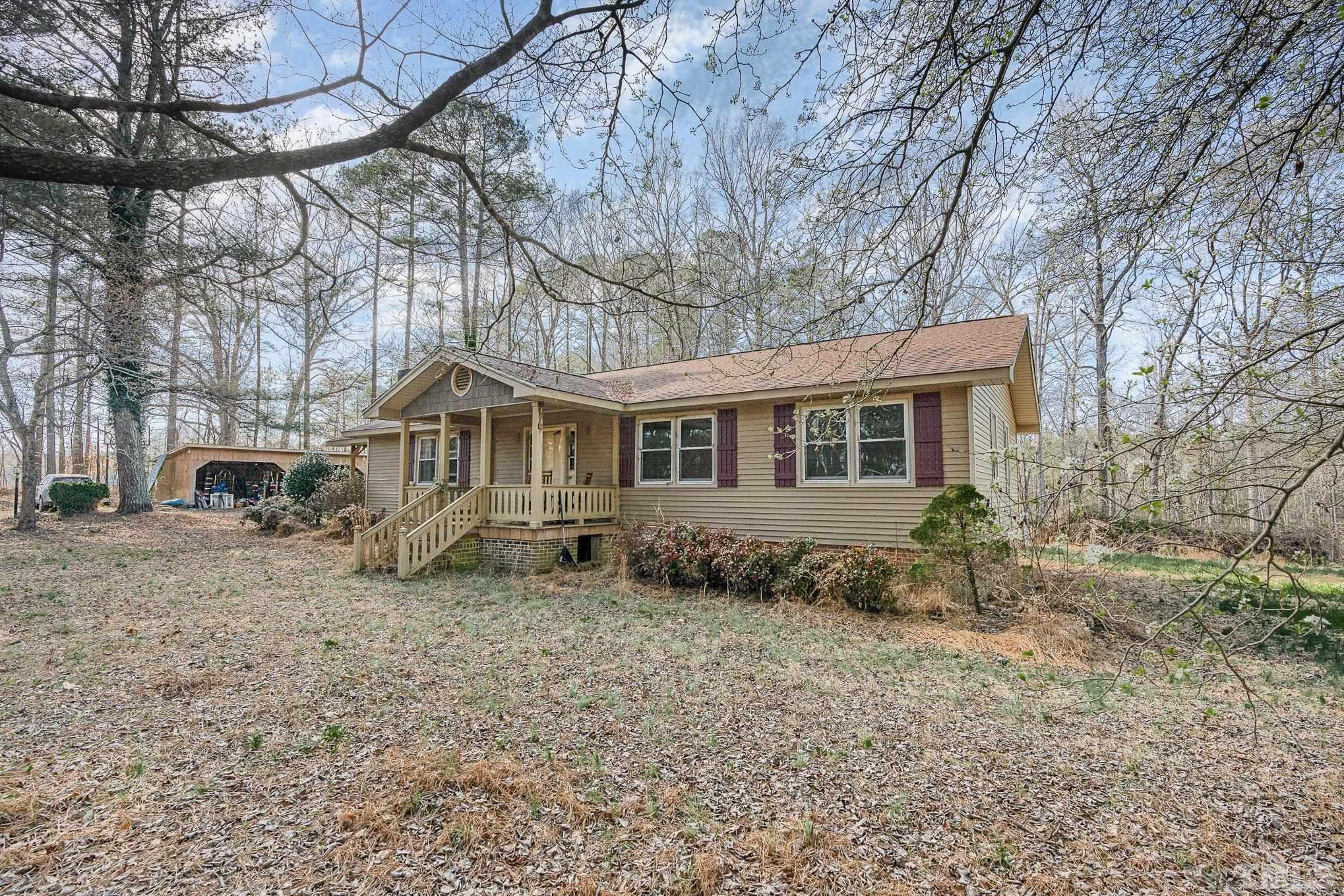 1613 Sanders Road Stem, NC 27581 - Photo 3 of 19 a front view of a house with a yard