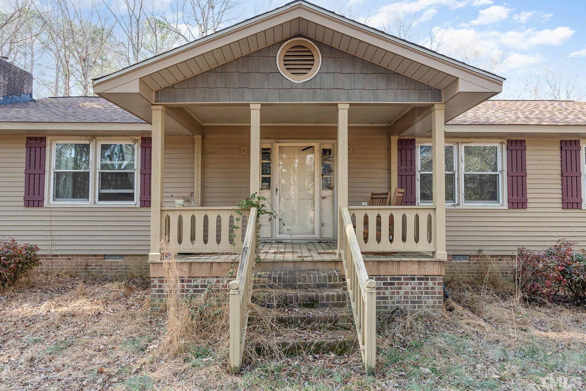 1613 Sanders Road Stem, NC 27581 - Photo 4 of 19 a front view of a house with stairs