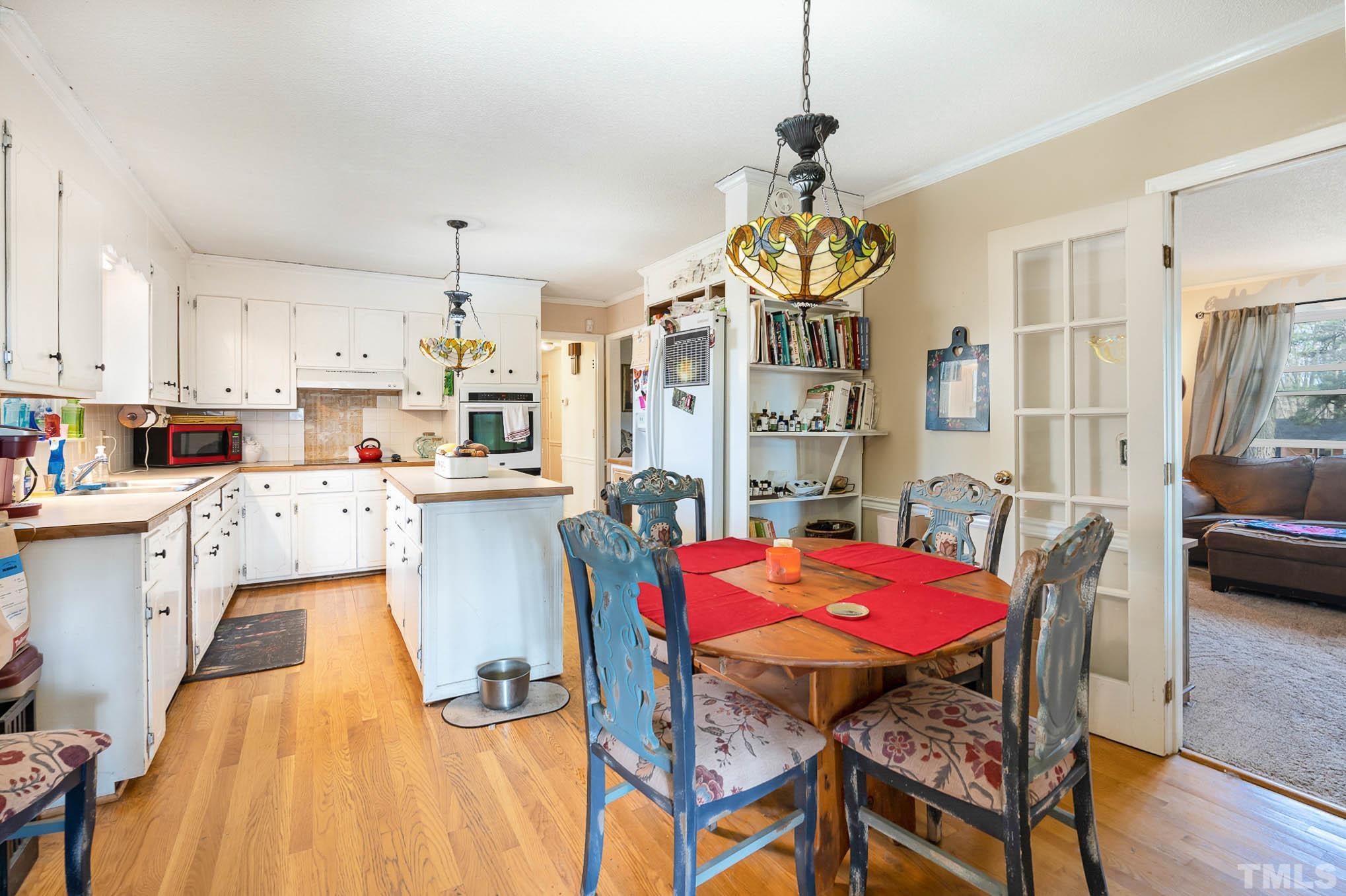 1613 Sanders Road Stem, NC 27581 - Photo 8 of 19 a view of kitchen with dining table and chairs