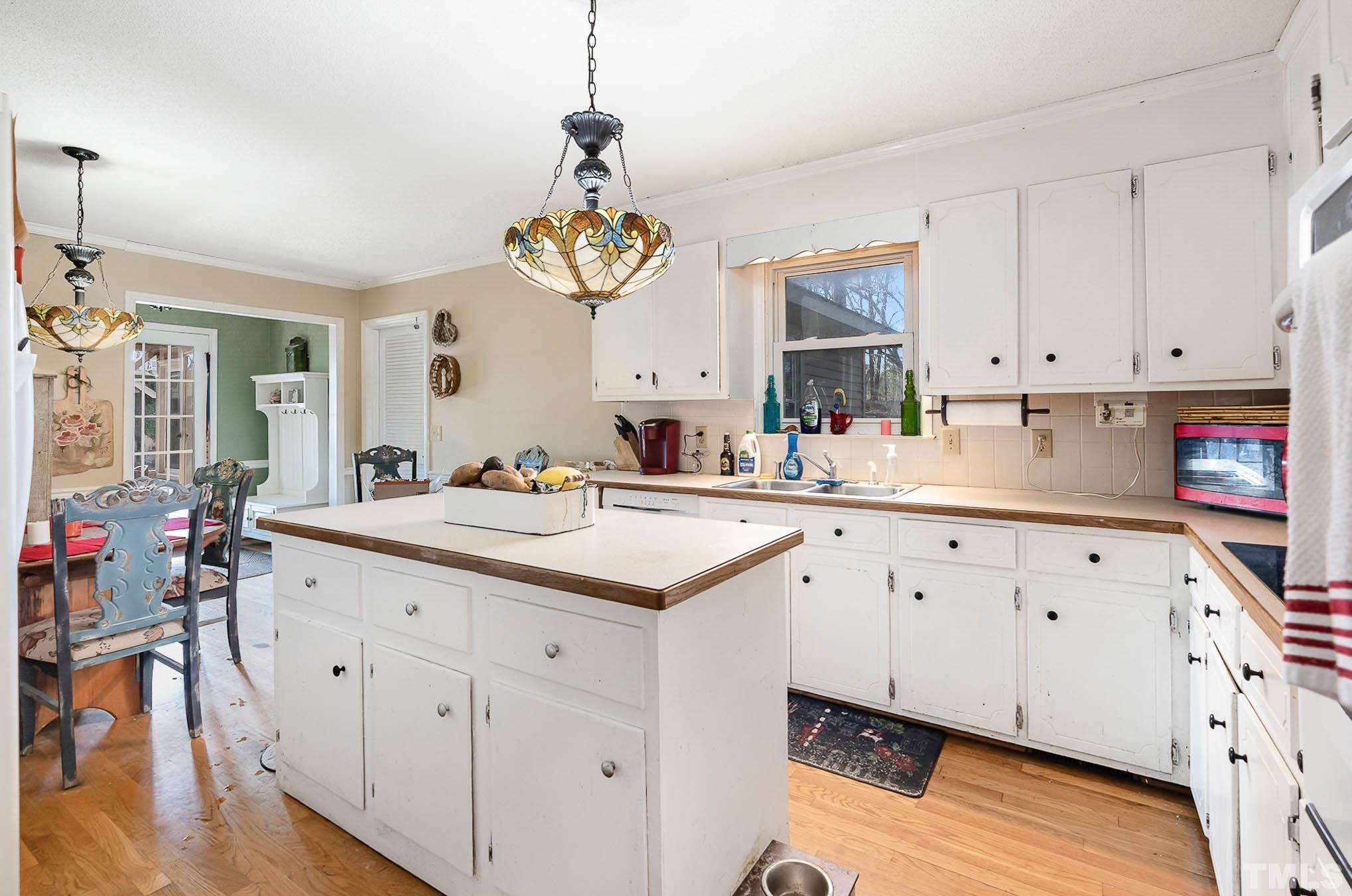 1613 Sanders Road Stem, NC 27581 - Photo 9 of 19 a kitchen with cabinets a sink and appliances