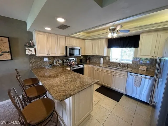 a kitchen with stainless steel appliances granite countertop sink stove top oven and microwave