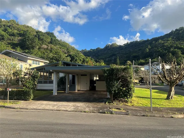 a view of a house with a garden and pathway