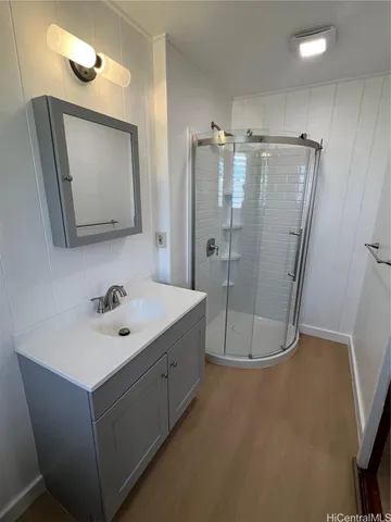 a bathroom with a sink a mirror and shower