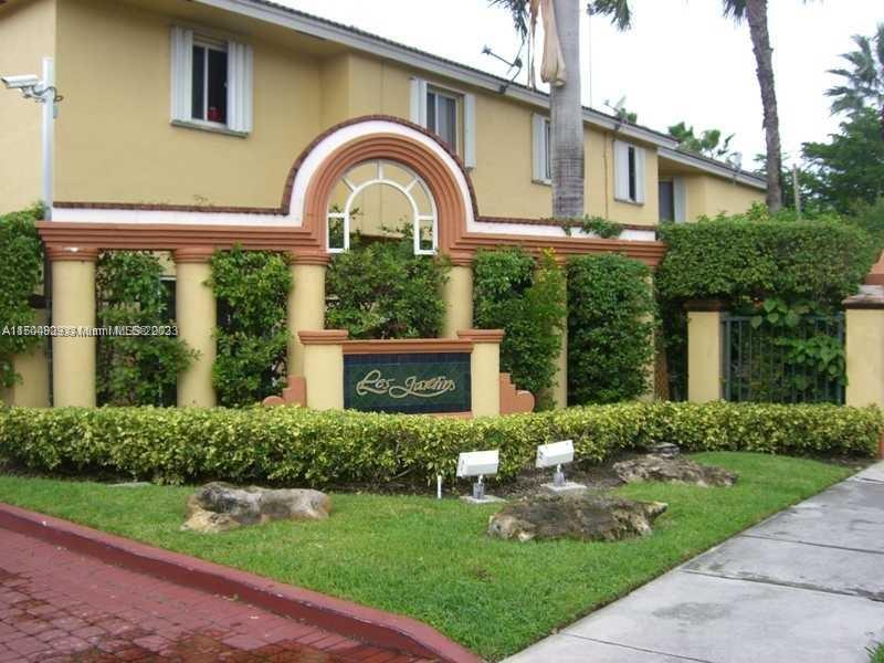 8260 Northwest 10th Street, Unit 7 Miami, FL 33126 - Photo 1 of 23 a front view of a house with garden