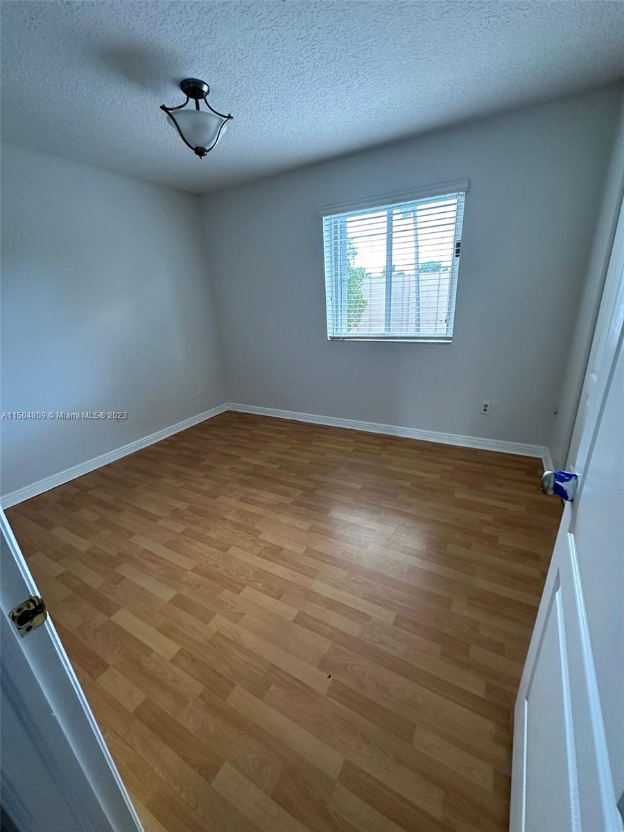 8260 Northwest 10th Street, Unit 7 Miami, FL 33126 - Photo 13 of 23 a view of an empty room with a window