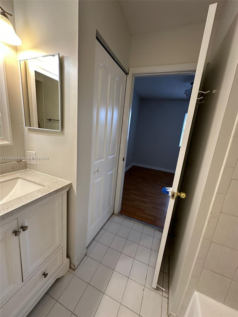 8260 Northwest 10th Street, Unit 7 Miami, FL 33126 - Photo 16 of 23 a view of closet and bathroom