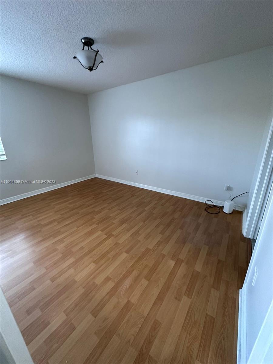 8260 Northwest 10th Street, Unit 7 Miami, FL 33126 - Photo 19 of 23 a view of empty room with wooden floor