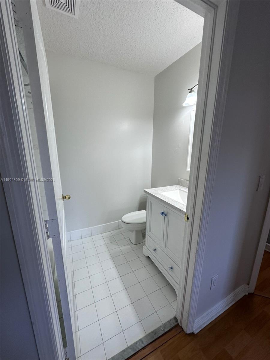 8260 Northwest 10th Street, Unit 7 Miami, FL 33126 - Photo 21 of 23 a bathroom with a sink and a toilet