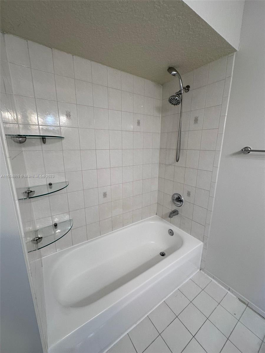 8260 Northwest 10th Street, Unit 7 Miami, FL 33126 - Photo 22 of 23 a bathroom with a bathtub and shower
