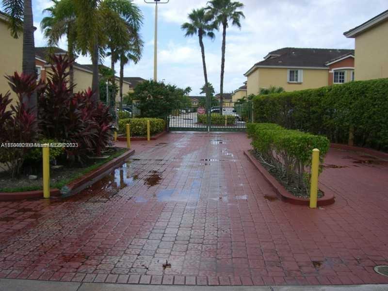 8260 Northwest 10th Street, Unit 7 Miami, FL 33126 - Photo 23 of 23 a view of a house with a yard and palm trees