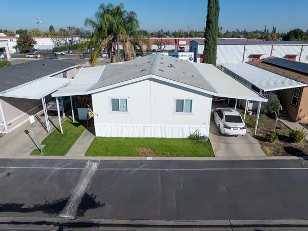 an aerial view of a house with garden space and street view