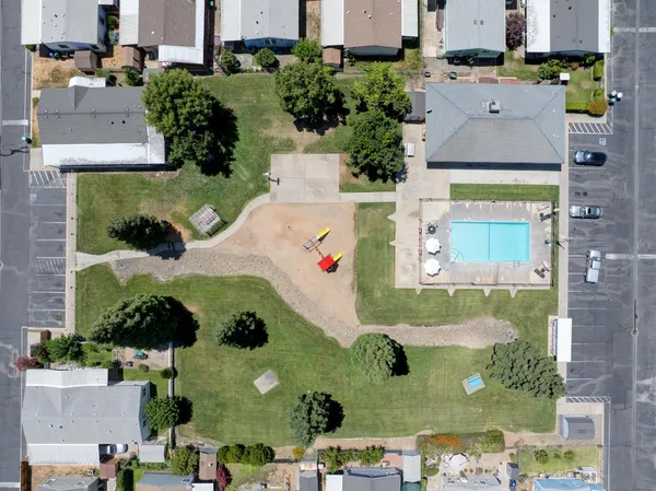 an aerial view of residential houses with outdoor space