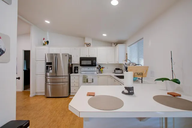 a kitchen with a sink a stove and cabinets