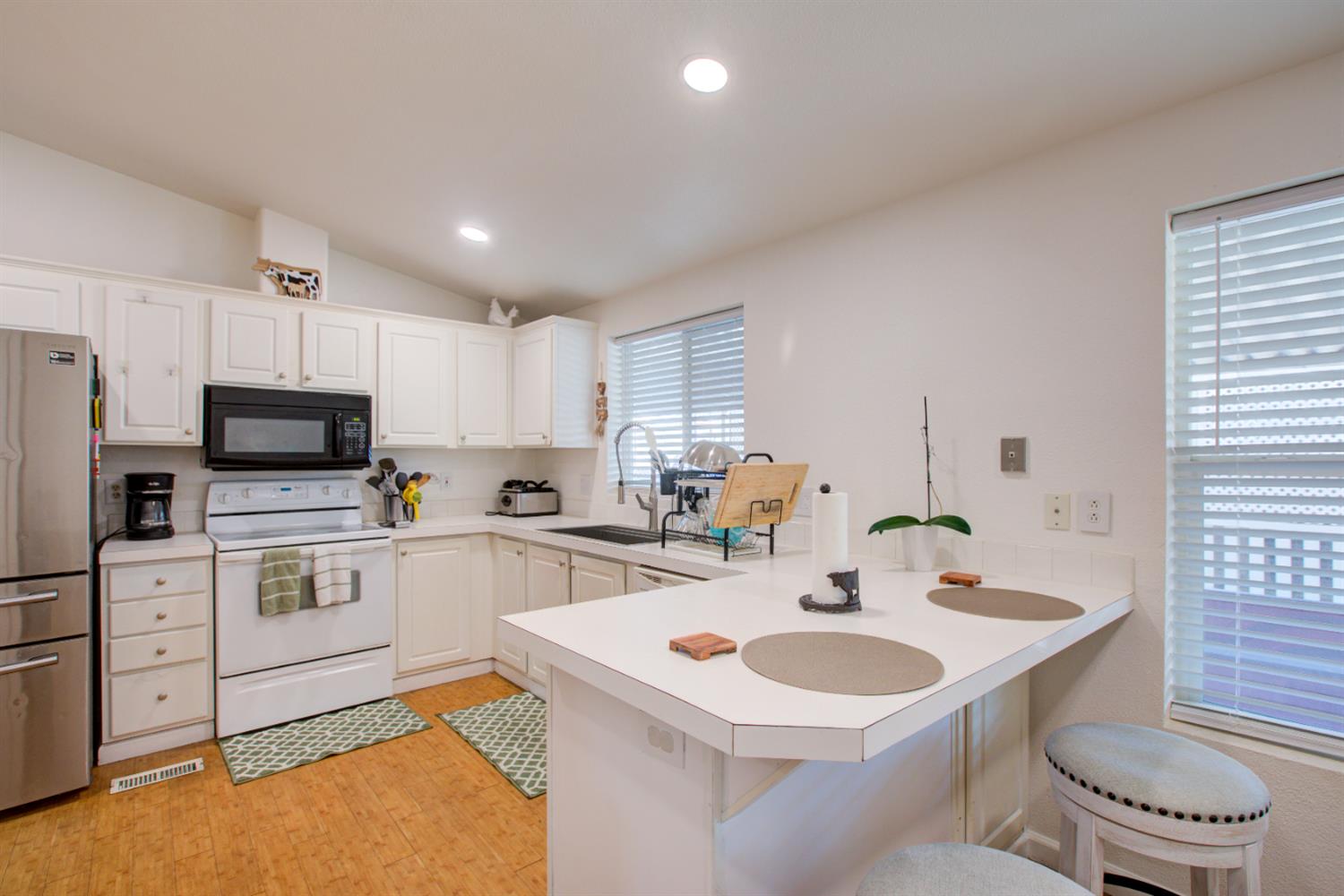 6450 North Winton Way, Unit 76 Winton, CA 95301 - Photo 6 of 36 a kitchen with a sink a stove and cabinets