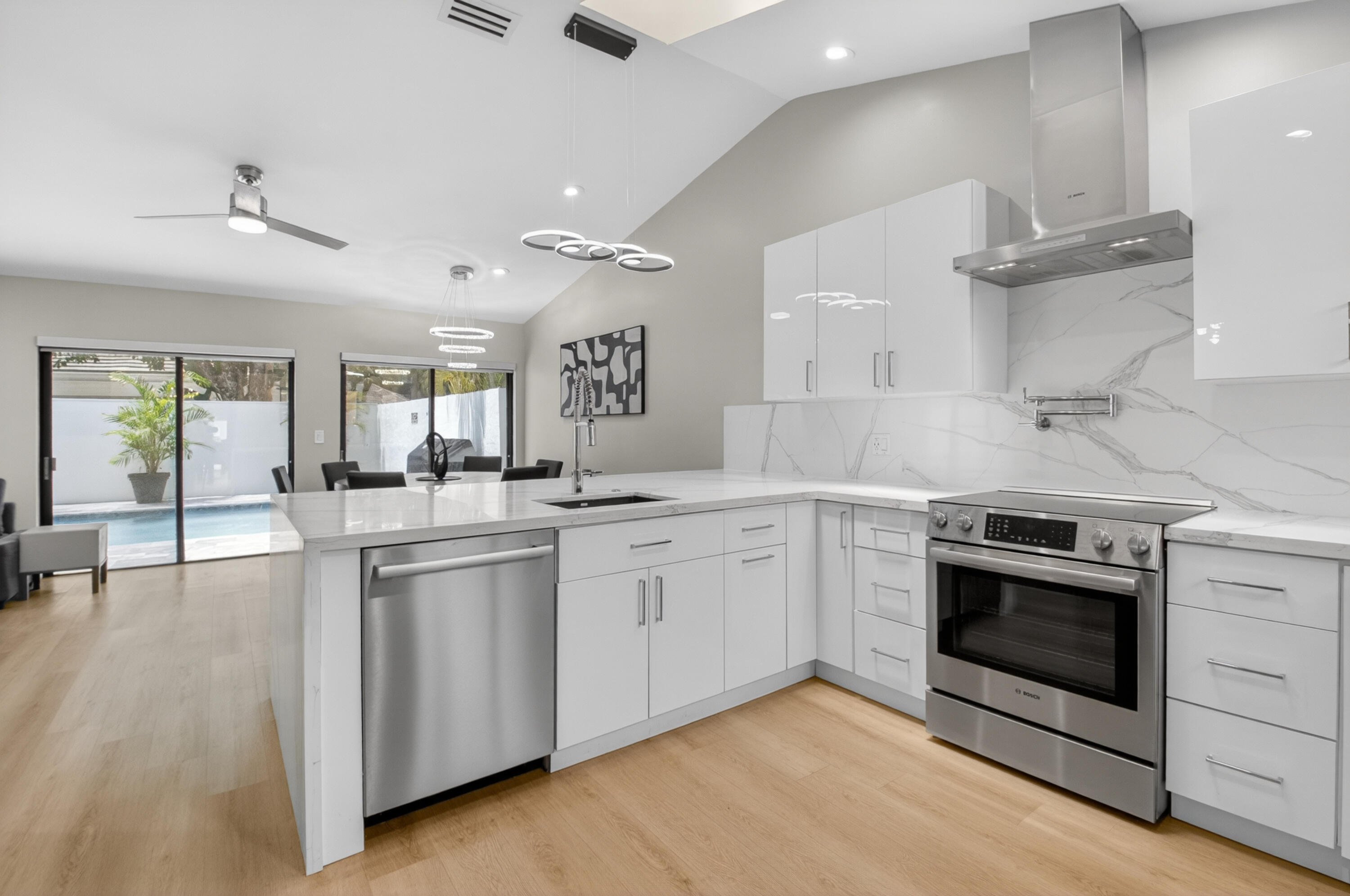 7374 Woodmont Court Boca Raton, FL 33434 - Photo 3 of 95 a kitchen with stainless steel appliances granite countertop a stove and a sink