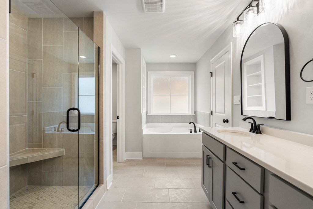 49 Altapass Way Fortson, GA 31808 - Photo 11 of 19 a bathroom with a tub sink and mirror