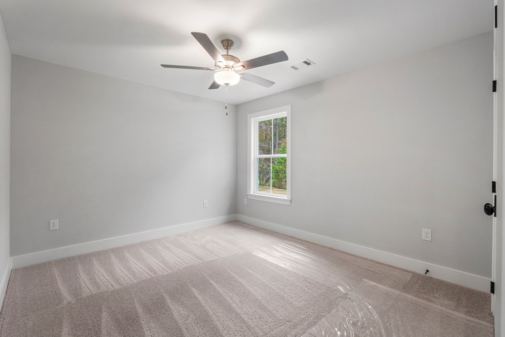 49 Altapass Way Fortson, GA 31808 - Photo 14 of 19 an empty room with a window and a fan