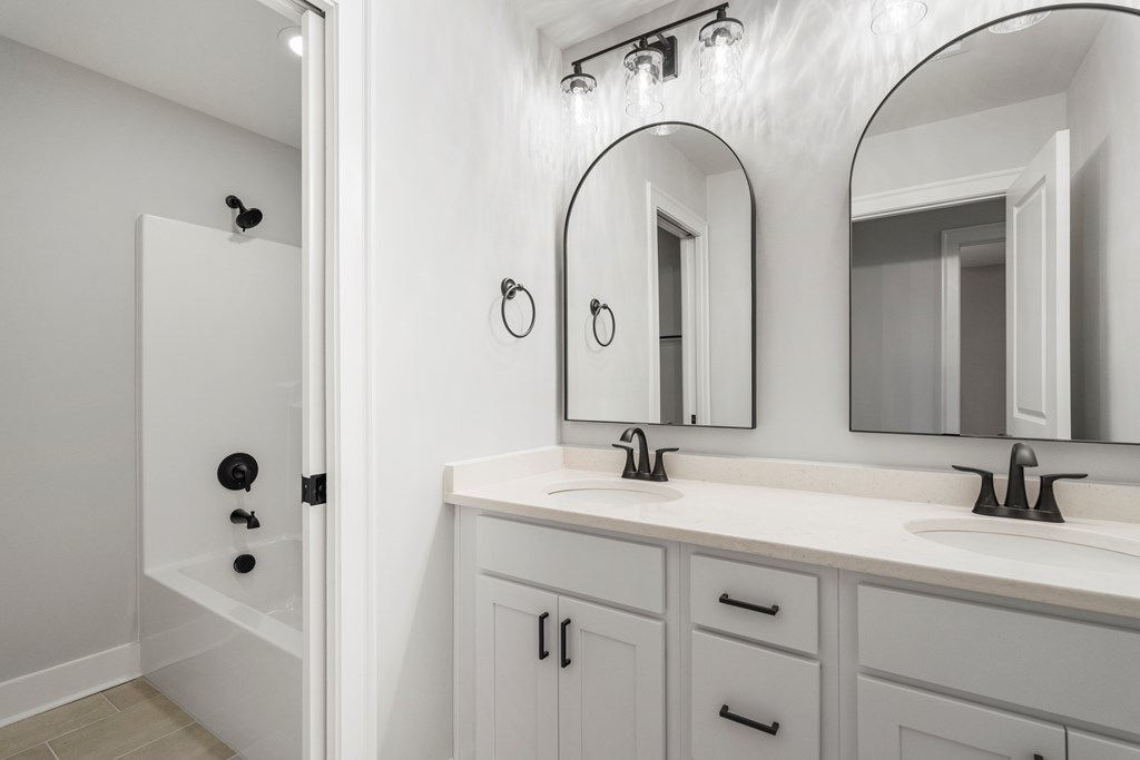 49 Altapass Way Fortson, GA 31808 - Photo 17 of 19 a bathroom with a granite countertop sink a mirror and shower