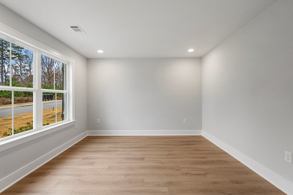 49 Altapass Way Fortson, GA 31808 - Photo 9 of 19 a view of empty room with wooden floor and fan