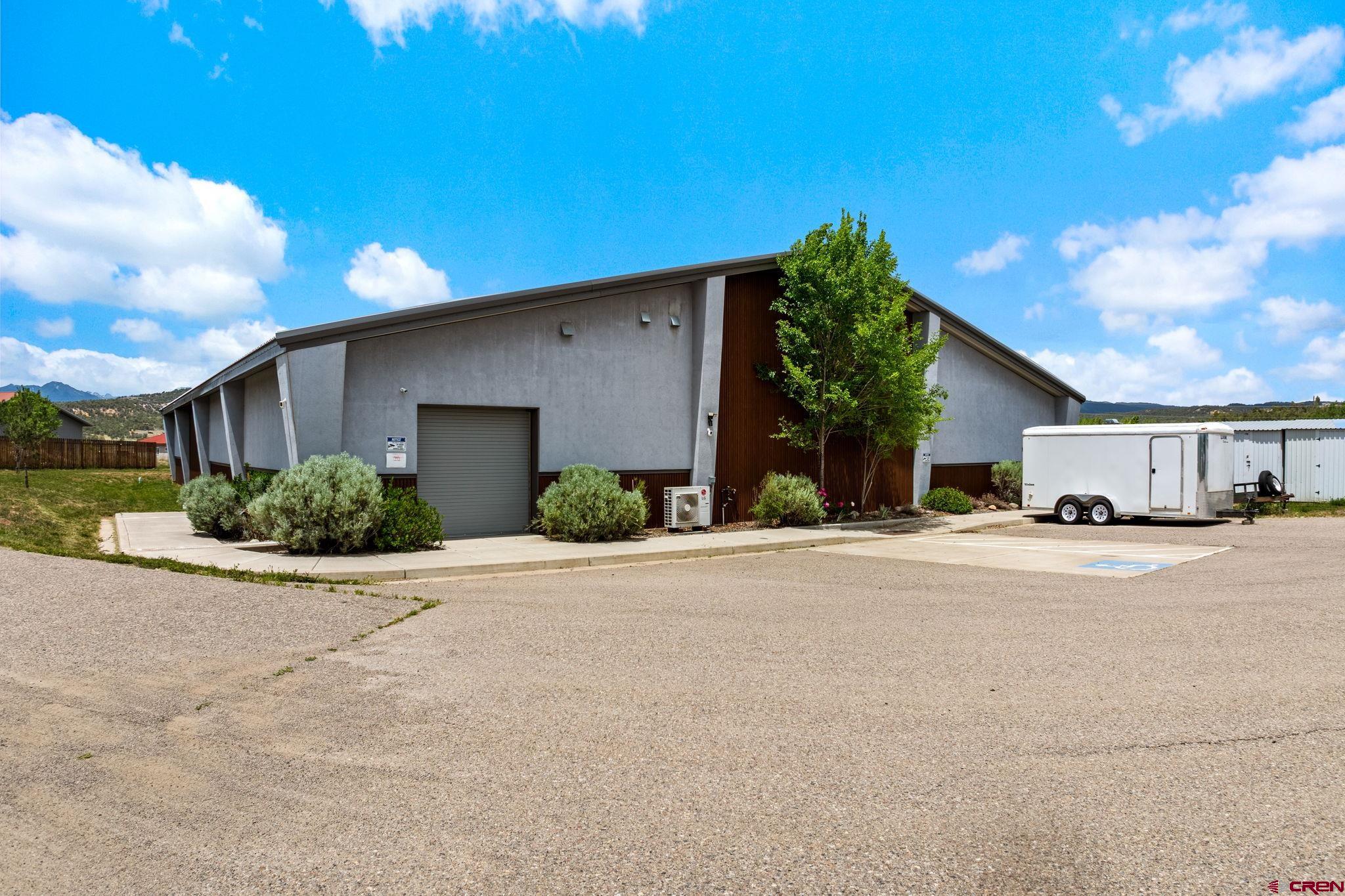 28753 Highway 160 Durango, CO 81301 - Photo 1 of 12 a front view of a house with a yard and garage