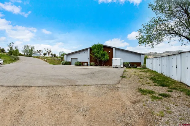 a view of a house with a yard and garage