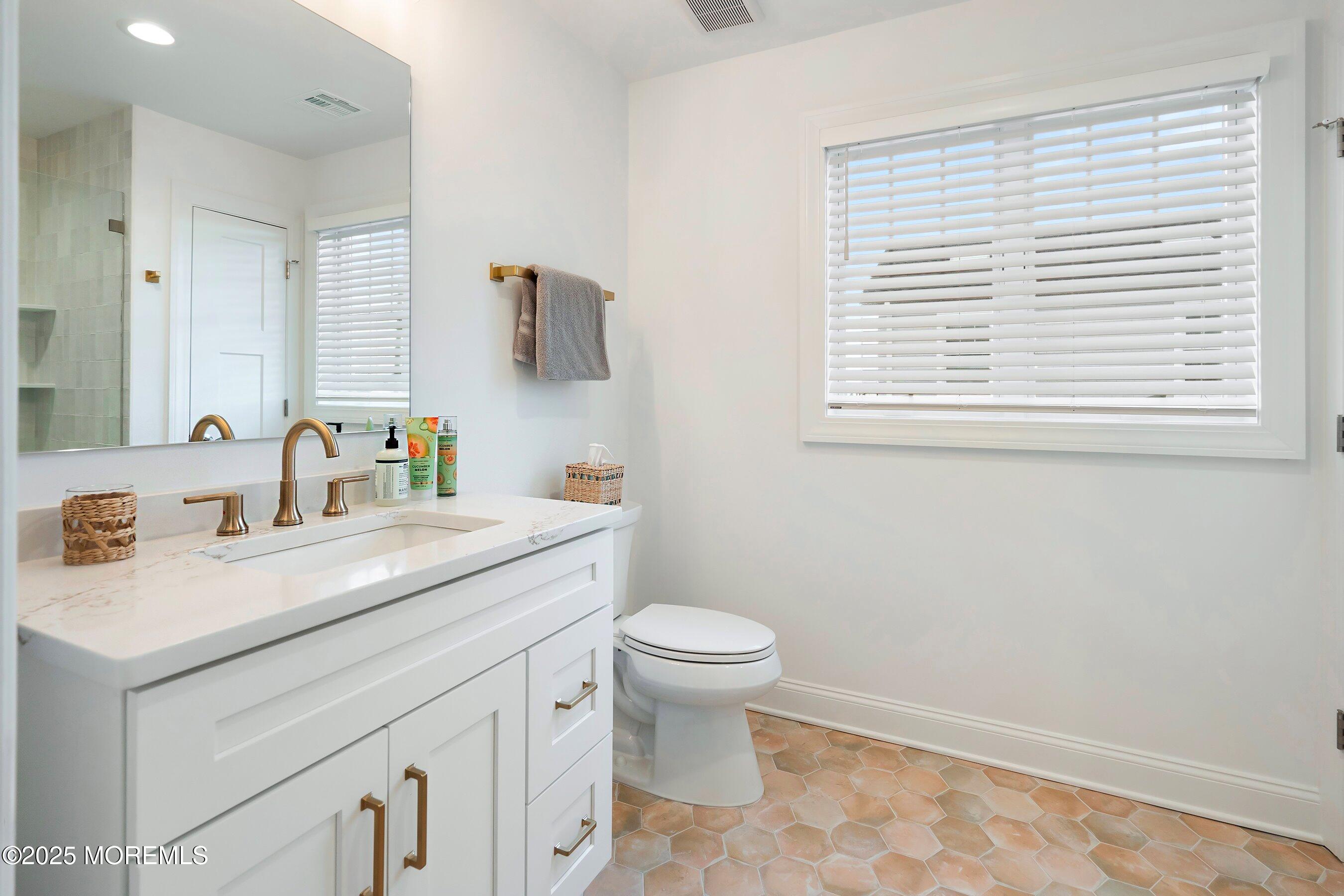 543 Brielle Road Manasquan, NJ 08736 - Photo 26 of 36 a bathroom with a sink a toilet and a window