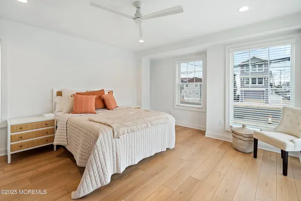 a spacious bathroom with a granite countertop toilet a sink a mirror and a window