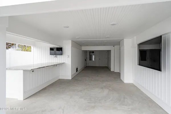 a view of a livingroom with furniture and a flat screen tv
